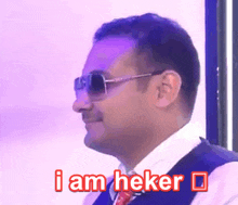 a man wearing sunglasses and a vest is saying i am beker