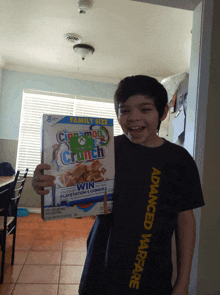 a boy holding a box of cinnamon crunch