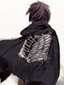 a man with purple hair is wearing a black cape with wings on it .