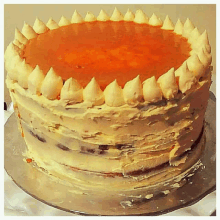 a cake with a yellow frosting and a orange topping