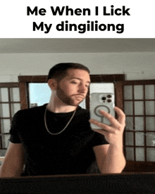 a man taking a selfie in front of a mirror with a caption that says me when i lick my dingiliong