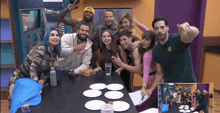 a group of people are standing around a table with plates on it