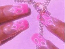 a close up of a person 's nails with pink flames and a necklace on a purple background .