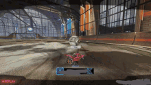 a rocket league game is being played and a replay button is visible