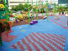 a colorful playground with blue and red tiles and a green butterfly sign