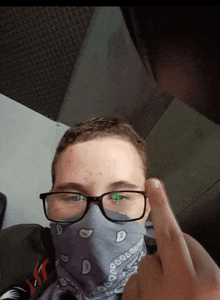 a young man wearing glasses and a bandana with a skull on it