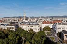 an aerial view of a city with a tower in the background