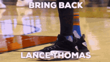 a basketball player with the name lance thomas on the side of his shoes