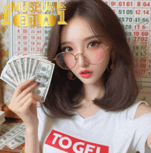 a woman wearing glasses and a t-shirt that says ' togel ' is holding a bunch of money