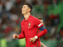 a soccer player wearing a red shirt that says ' world cup ' on the front