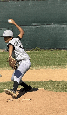 a baseball player wearing a jersey that says tigers on it