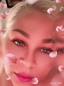 a woman 's face is surrounded by pink petals and the date june 10, 2023