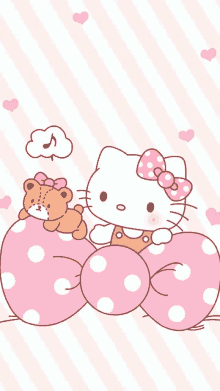 hello kitty is holding a teddy bear on a pink polka dot pillow