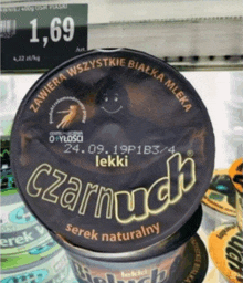 a container of czarnuch serek naturalny sits on a shelf in a store