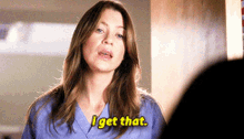 a woman in a blue scrub is saying i get that