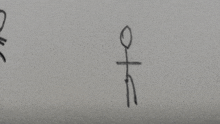 a stick figure is drawn on a piece of paper with a cross on it