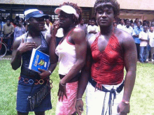 a group of people are posing for a picture and one of them is holding a book that says ' african languages '