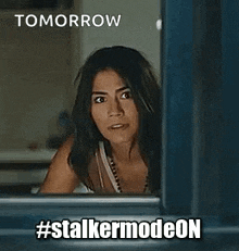 a woman is peeking out of a window with the words `` tomorrow #stalkermodeon '' .