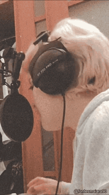 a person wearing headphones that say dt 770 pro on them