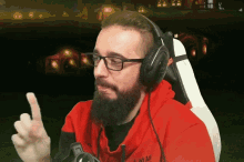 a man with a beard wearing headphones and a red shirt that says ' astar ' on the front