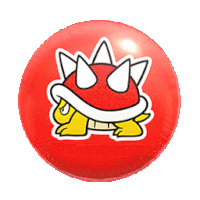 a red ball with a sticker of a cartoon turtle on it