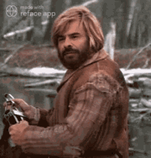 a man with long blonde hair and a beard is sitting in the woods holding a sword .