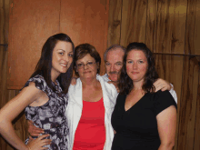 a man and two women pose for a picture together