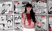 a woman stands in front of a wall of cartoons with the year 2005 on it