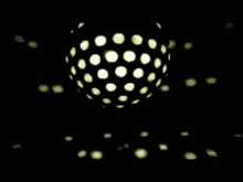 a disco ball with dots on it is spinning in the dark