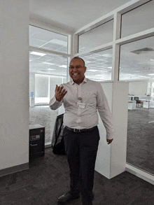 a man in a white shirt with a name tag that says ' abdullah '