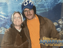 a man and a woman pose for a picture at ripley 's aquarium of the smokies