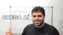 a man giving a thumbs up in front of a whiteboard that says chega ai