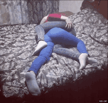 a couple laying on a bed with their legs crossed and their feet visible