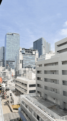 a view of a city with a lot of buildings and a blue sky