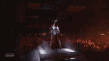 a woman dancing on a pole in front of a crowd with stagemagic written on the bottom right