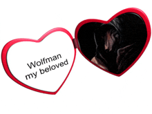 a red heart shaped mirror with the words wolfman my beloved