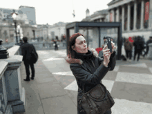 a woman taking a picture of herself with a cell phone