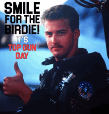 a man giving a thumbs up with the words smile for the birdie it 's top gun day below him