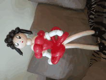 a balloon figure of betty boop is sitting on a couch