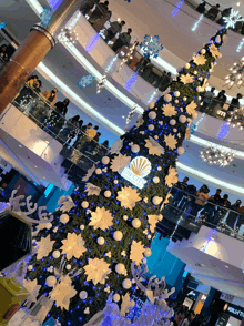 a large christmas tree in a mall with the word plaza on the top