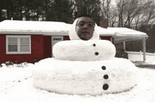 a large snowman with a man 's face on top of it .