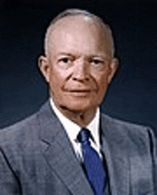 a man in a suit and tie is posing for a picture .