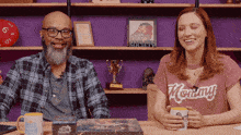 a man and a woman are sitting at a table with a mug that says good morning america on it