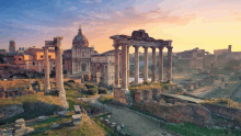 the ruins of the roman forum at sunset with a dome in the background