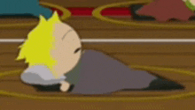 a cartoon character is laying on a wooden floor in a circle .