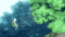 a girl is jumping into a body of water surrounded by trees