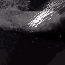 a close up of a shower head spraying water on a person 's arm .