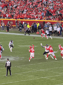 a football player with the number 15 on his jersey is being tackled by a player with the number 7 on his jersey