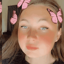 a girl with pink butterflies in her hair looks at the camera