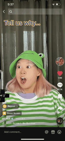 a woman wearing a green hat and a green and white striped shirt is on a tiktok video